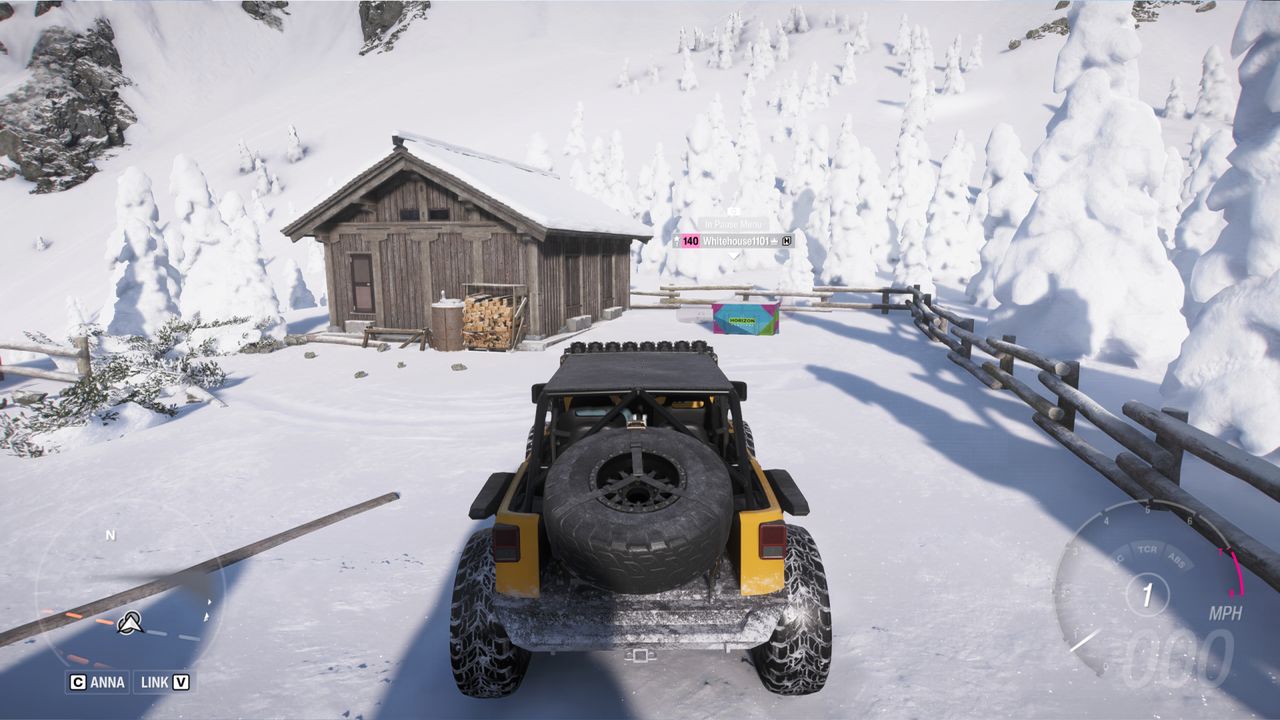Forza Horizon 6 Sotoyama Treasure Hunt: A yellow Jeep Wrangler looking at a treasure chest next to a wooden cabin on a snowy mountain.