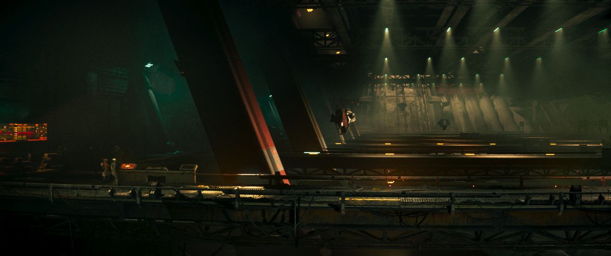 Babiru DaVinci Resolve tips; A visually striking futuristic scene captures a narrow industrial space with dramatic lighting, where a lone figure is suspended in mid-air, suggesting a moment of heightened tension or movement.