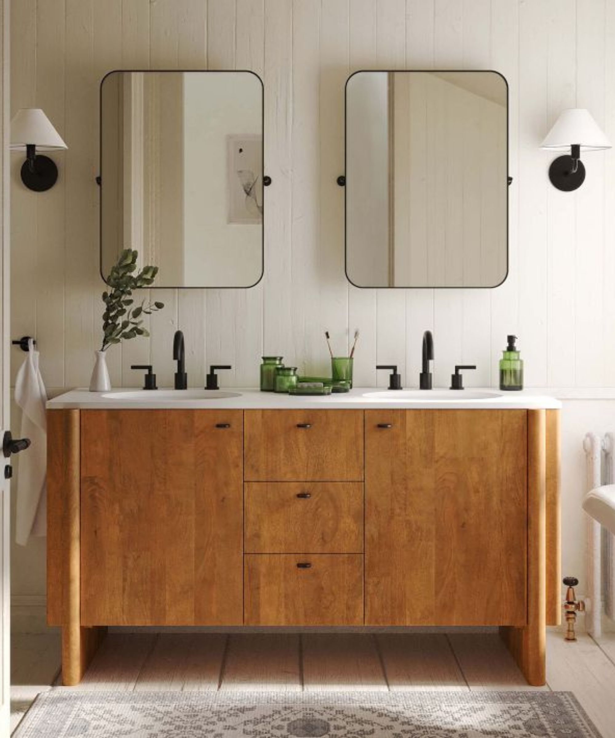 A white paneled bathroom with a wooden double vanity and black wall lights