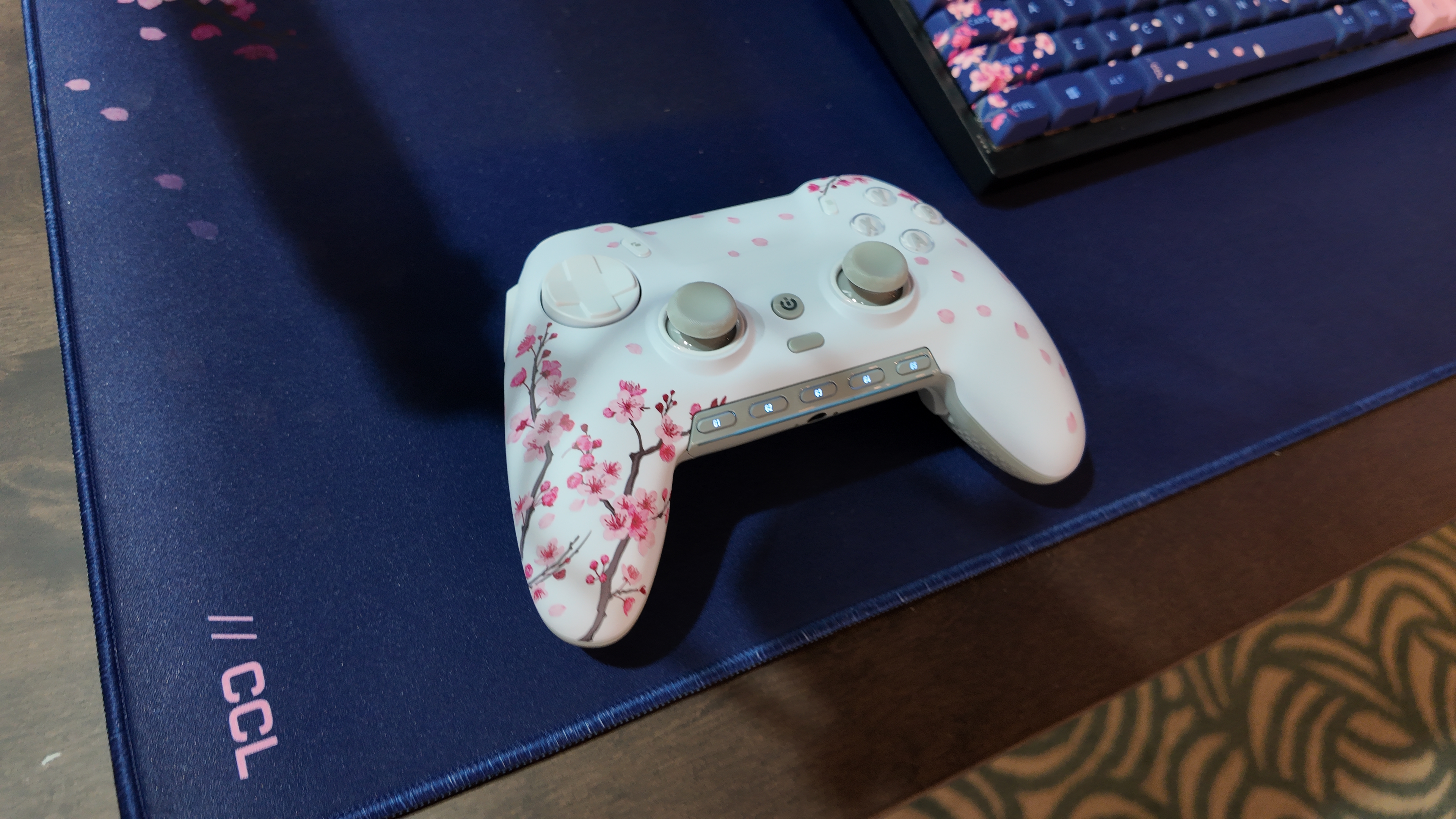Scuf Envision Pro controller with Hall effect sticks on a desk pad next to a keyboard