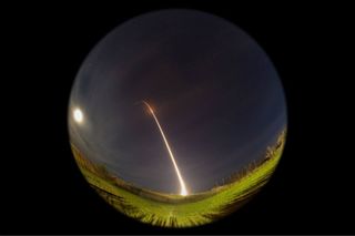 An Orbital Sciences Minotaur 1 rocket streaks toward space in this long-exposure view of the Air Force's ORS-3 mission launch of 29 small satellites from Pad 0B at the Mid-Atlantic Regional Spaceport at NASA's Wallops Flight Facility on Wallops Island, Va