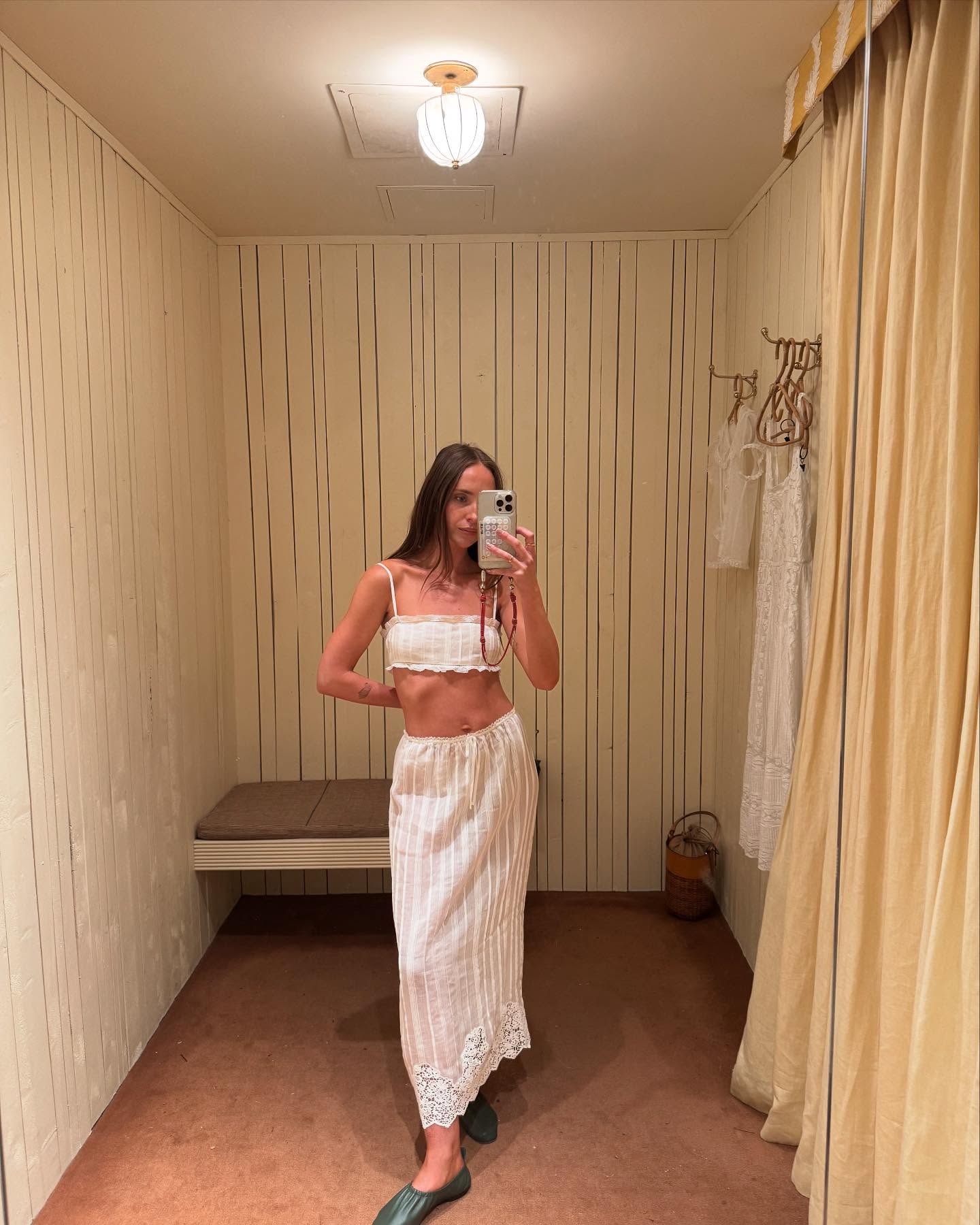 An image of @makenna_alyse wearing a pintuck top from Doen with a matching skirt and ruched ballet flats.