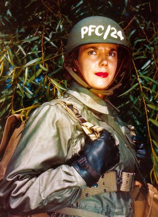 A member of the US Army Women's Auxiliary Army Corps (WAAC) wearing red lipstick and an M43 field jacket, circa 1944