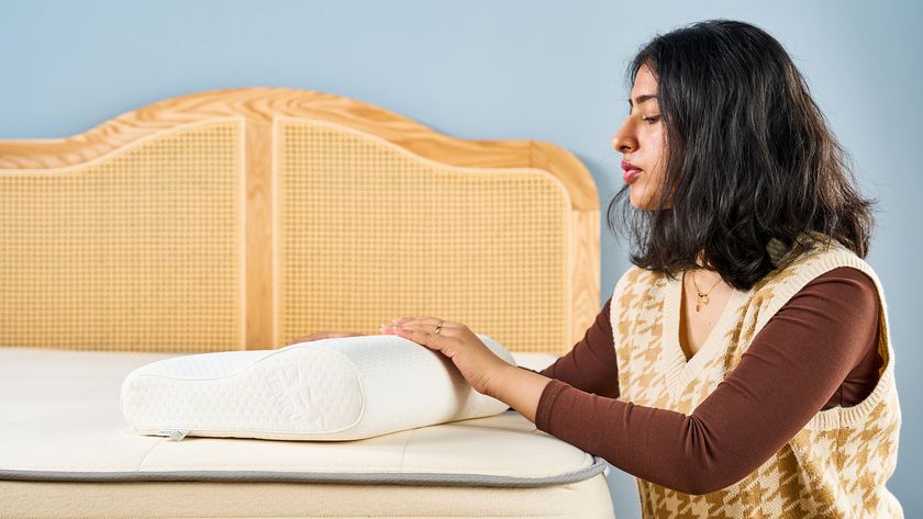 Woman placing her hand over a white pillow 