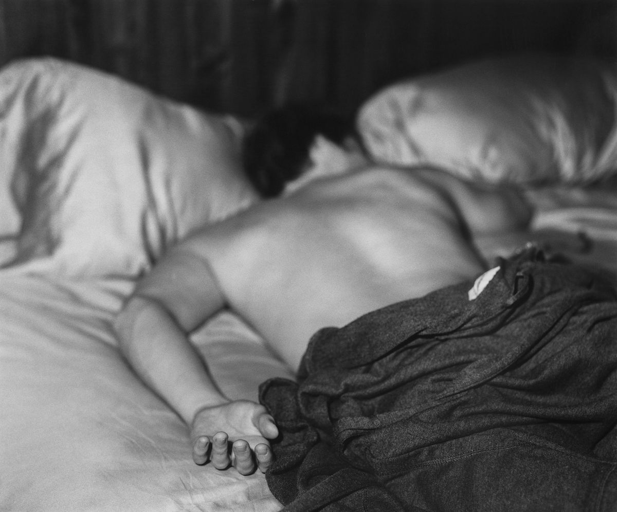 a black and white image of someone led in bed