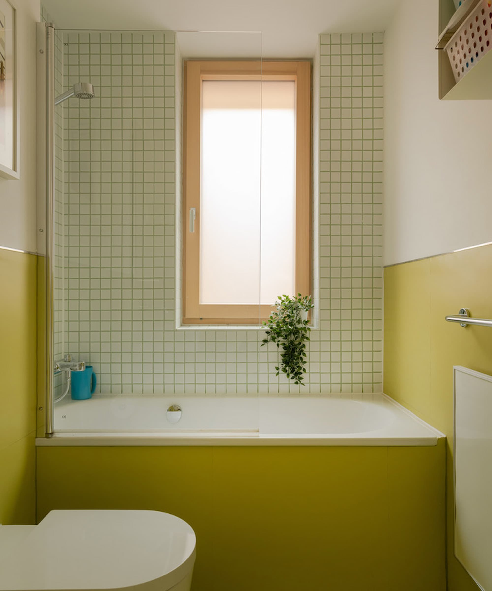 A green bathroom and a wooden window