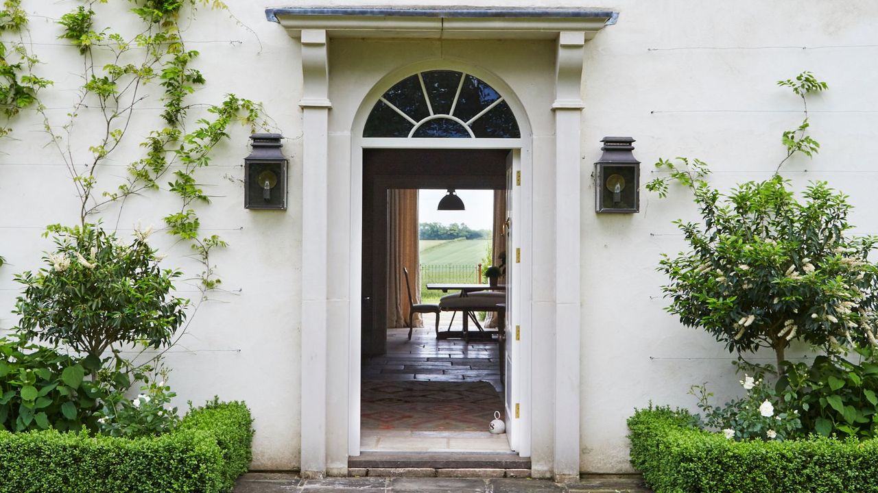 Two garden wall lights next to an open door