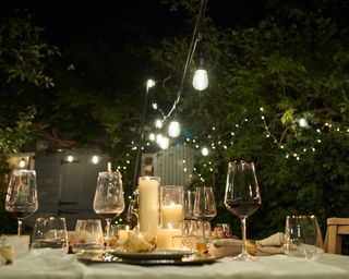 outdoor table at night with candles and lights