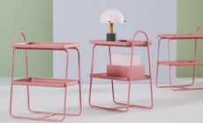 A set of pink metal racks with a mushroom table lamp