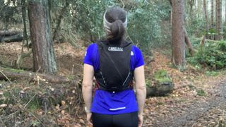 Runner from behind wearing the Camelbak Apex Pro running vest