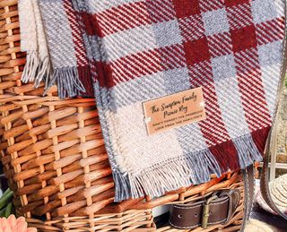 Wool-mix check printed picnic blanket laid over wicker basket