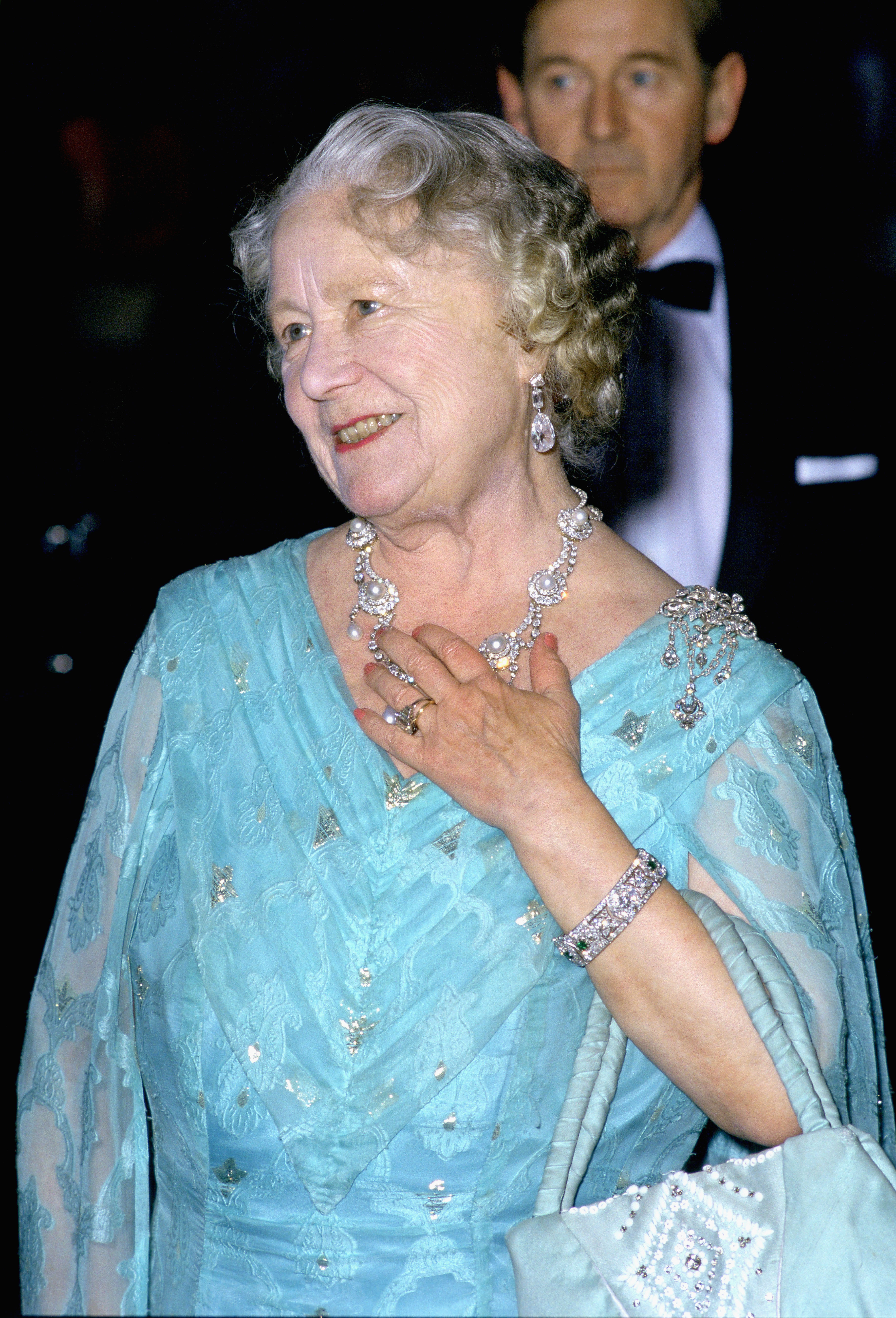 Queen Mother wearing a turquoise dress and diamond necklace