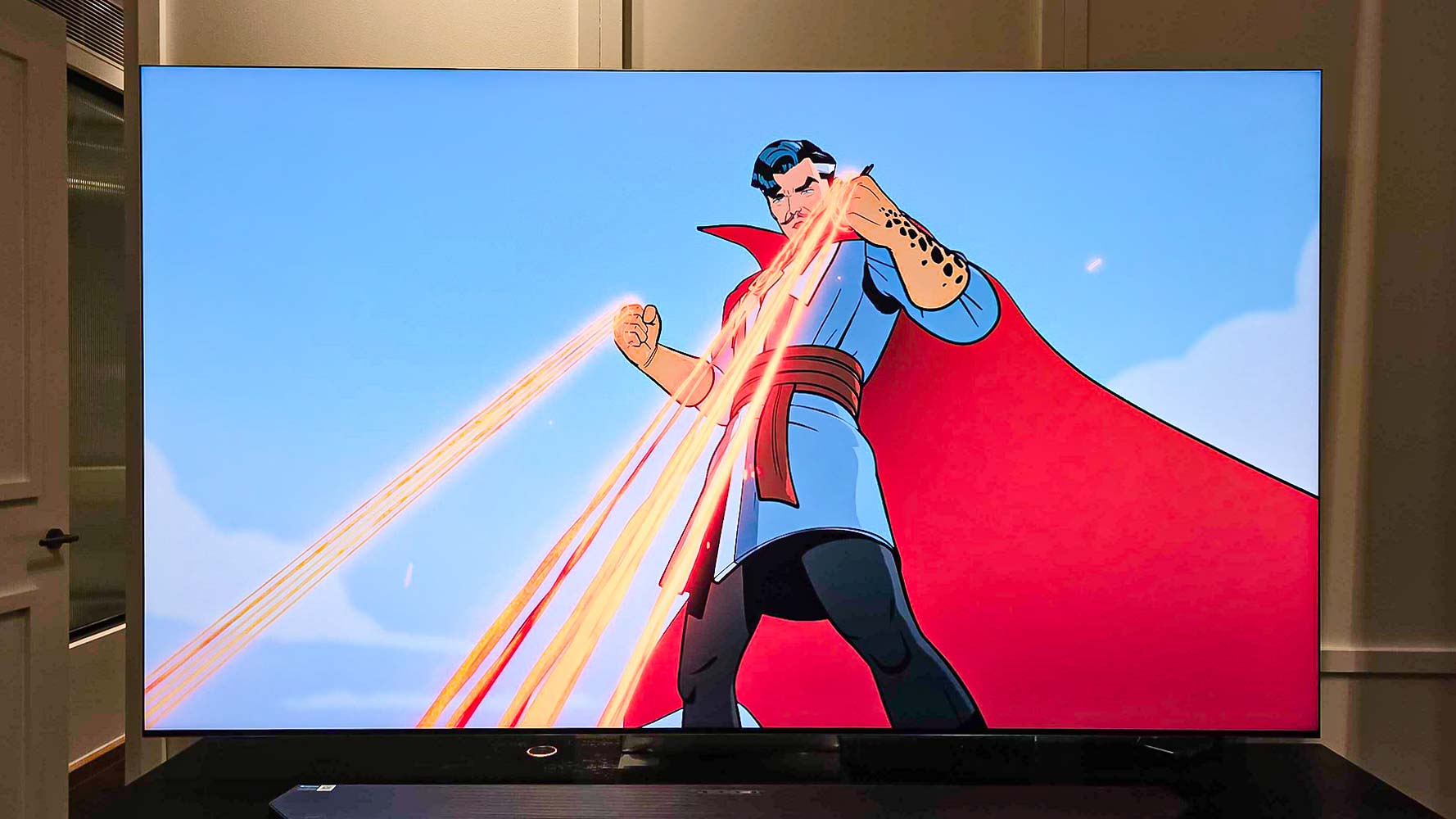 A Samsung QN990F on a TV stand.