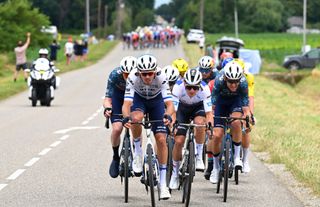 PAU FRANCE JULY 12 LR Christophe Laporte of France and Team Visma Lease a Bike Remco Evenepoel of Belgium and Team Soudal QuickStep White Best Young Rider Jersey Tiesj Benoot of Belgium and Team Visma Lease a Bike and Tadej Pogacar of Slovenia and UAE Team Emirates Yellow Leader Jersey compete in echelons formation due to the crosswind during the 111th Tour de France 2024 Stage 13 a 1653km stage from Agen to Pau UCIWT on July 12 2024 in Pau France Photo by Tim de WaeleGetty Images