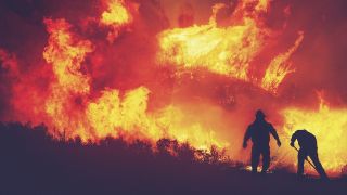 Two people fighting a wildfire