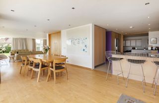 Kitchen area with wooden flooring and white wall