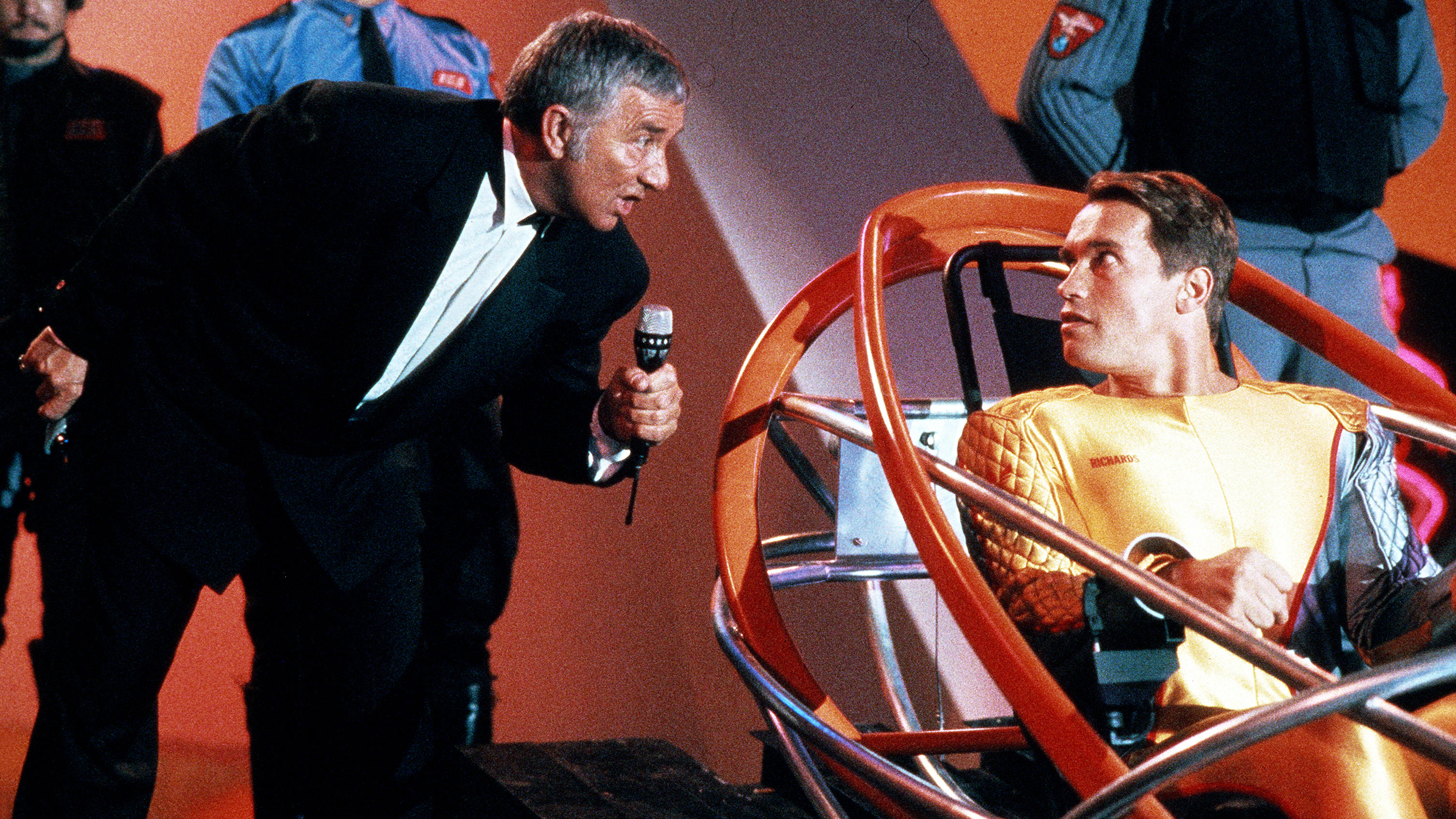 L-R: Killian (Richard Dawson) and Ben Richards (Arnold Schwarzenegger) on-stage from a scene in &quot;The Running Man&quot; (1987)