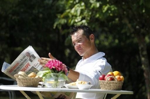 Thomas Voeckler poses in the traditional "reading the paper" pose on the Tour's rest day