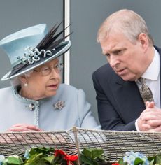 Queen Elizabeth in a pale blue suit talking to Prince Andrew