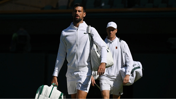 Novak Djokovic and Jannik Sinner walk out onto Center Court for their semifinal in the men's singles at Wimbledon 2025.