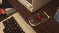 The Commodore Callback 8020 flip phone in beige.