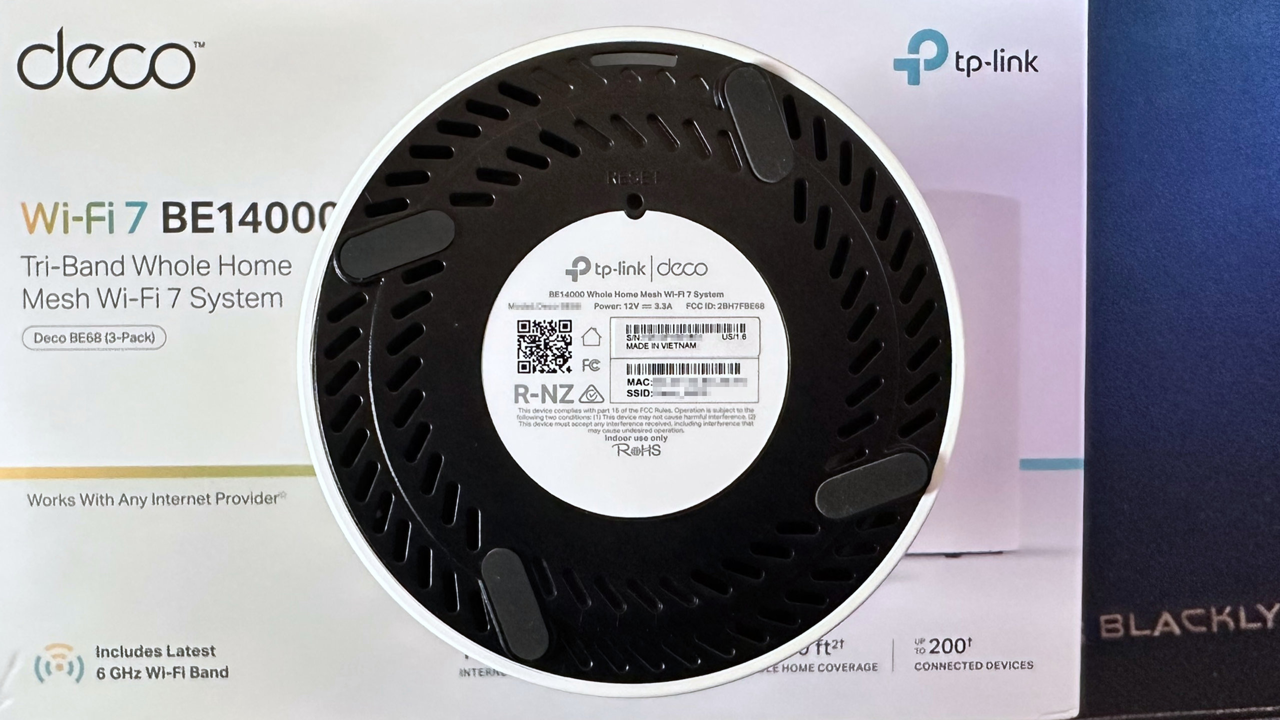 A photo showing the underside of a TP-Link Deco BE68 mesh router.