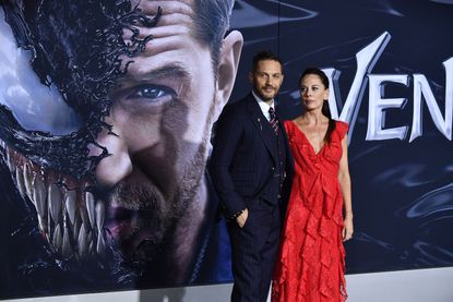 Tom Hardy and Kelly Marcel attend the Venom premiere.