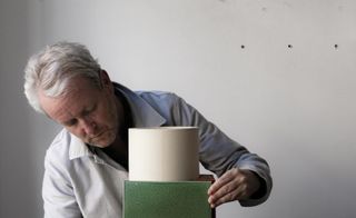 Ronan Bouroullec with ceramic vase in his studio
