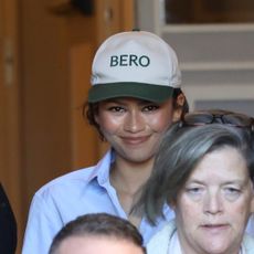 Zendaya wearing a Bero cap, referencing rumored husband Tom Holland's brand during a shopping trip in Rome, Italy, paired with cuffed jeans, a shirt, and The Row loafers