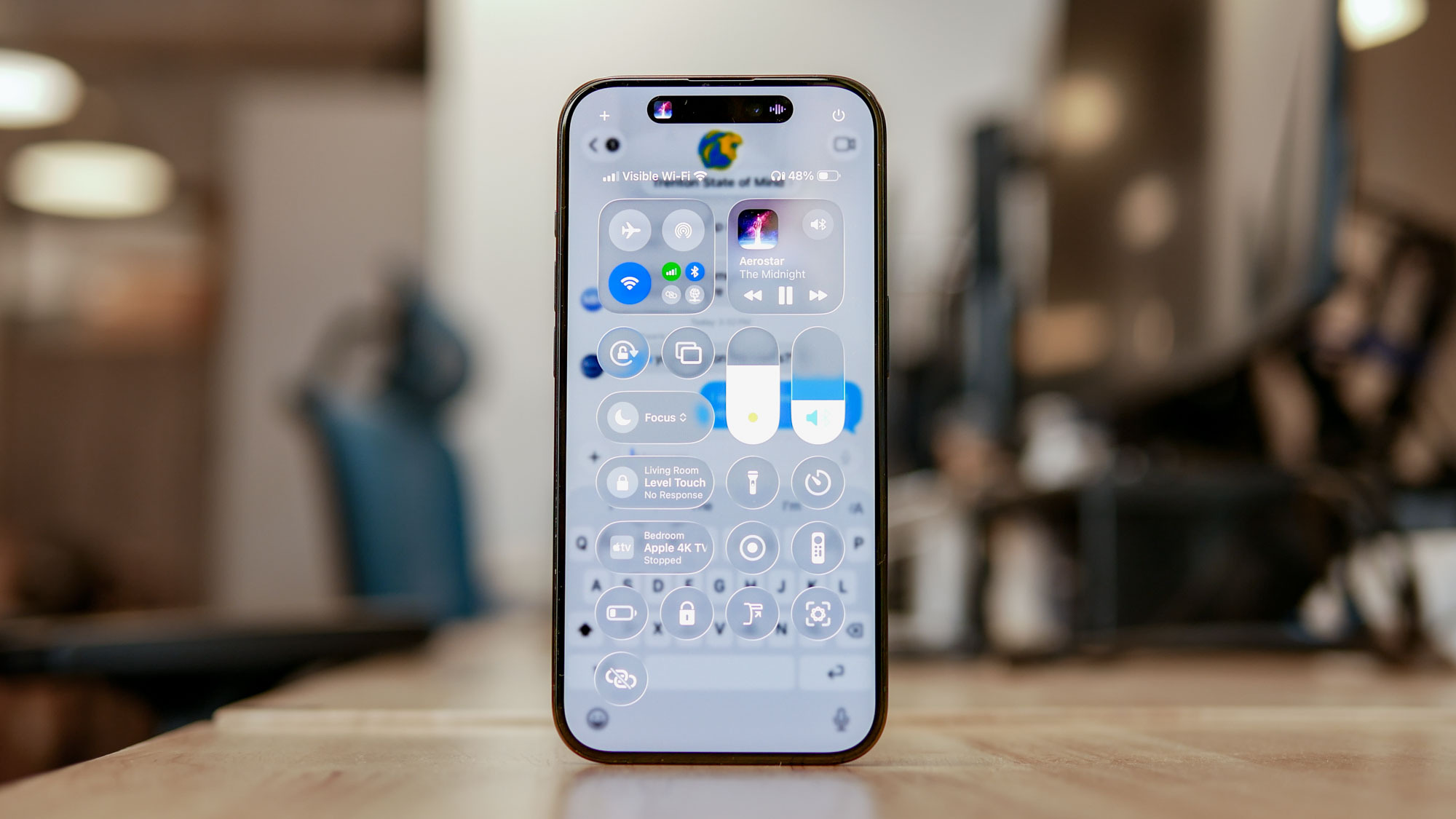 iOS 26 developer beta running on iPhone showing Liquid Glass interface.