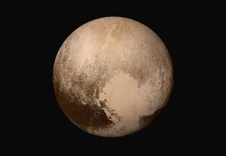 The dwarf planet Pluto is seen in true color in this stunning four-image mosaic created by photos from NASA's New Horizons spacecraft during the probe's historic flyby in July 2015. NASA unveiled the image on July 24.