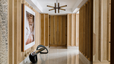 a wooden paneled entryway with terrazzo floor