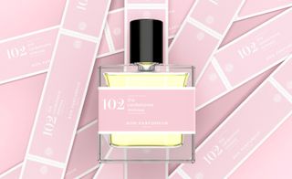 Perfume bottle labelled 102 with pink background