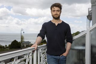 Daniel Radliffe poses on a balcony