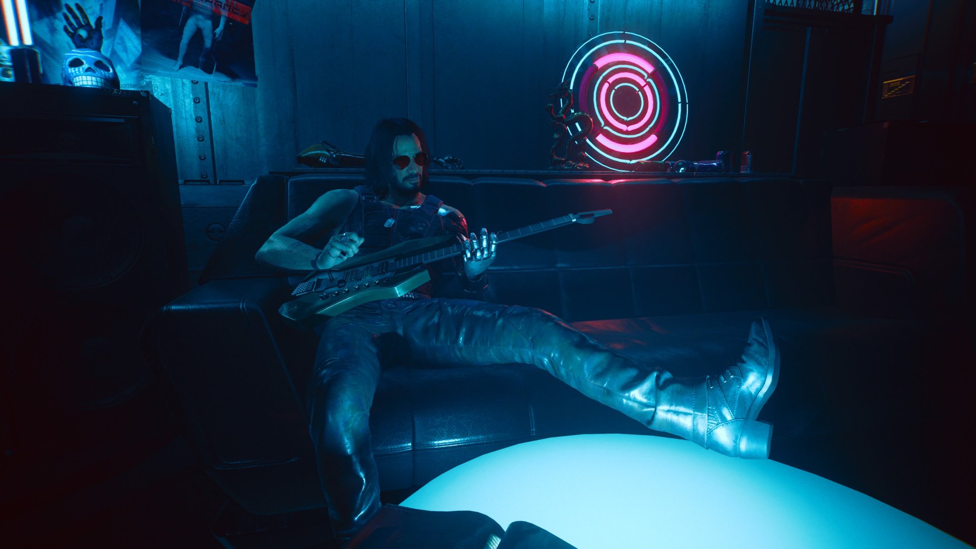 Cyberpunk 2077 screenshot showing Johnny Silverhand playing his guitar, stretched out on a couch