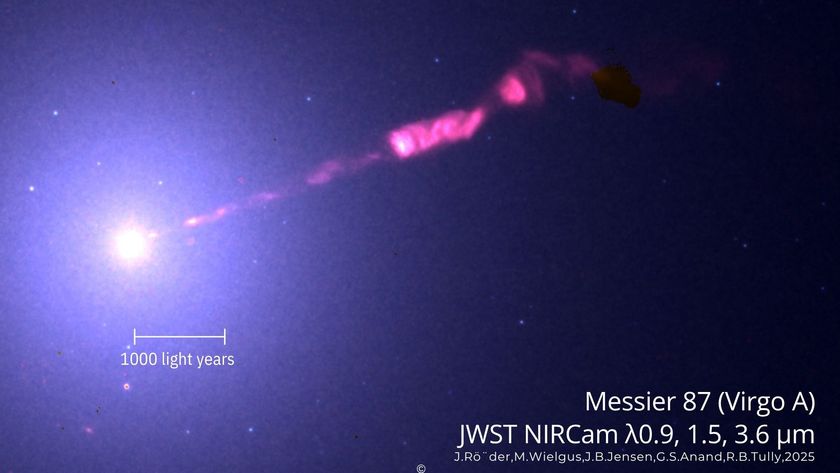 A hazy trail of pink gas is expelled from a bright light representing black hole M87 in the darkness of space with the words &quot;JWST NIRCAM&quot; on the bottom of the image