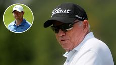 Butch Harmon looks on whilst Rory McIlroy stares off the tee