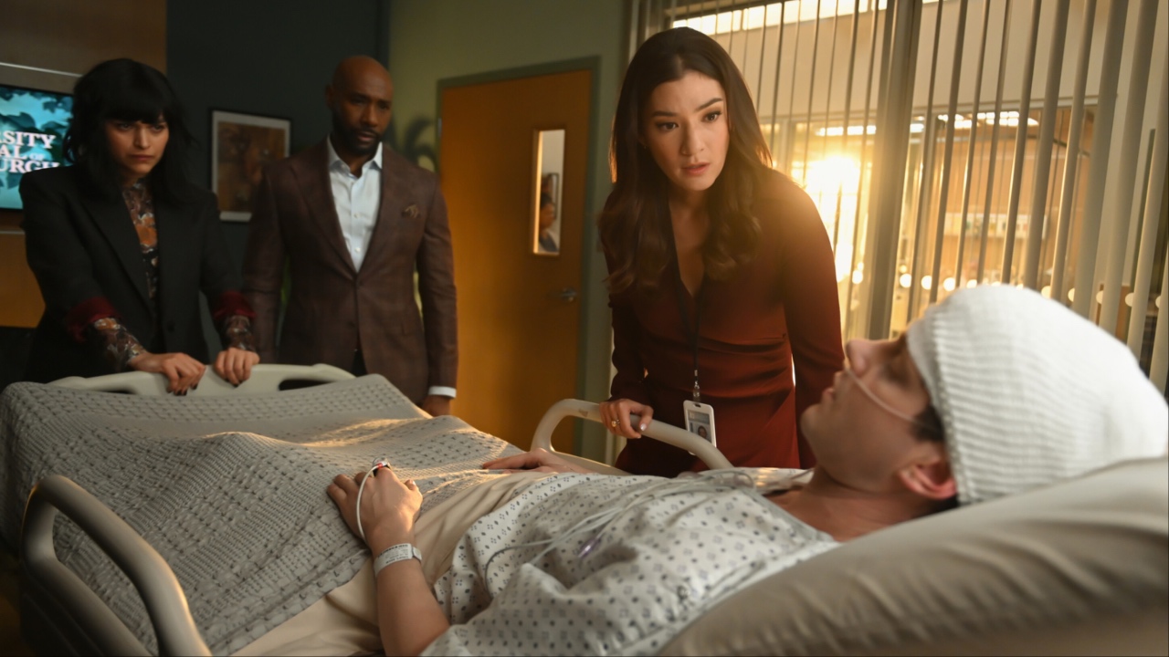 Ingrid, John, and Sasha Lubbock looking at Stephens in a coma in Watson Season 1x13