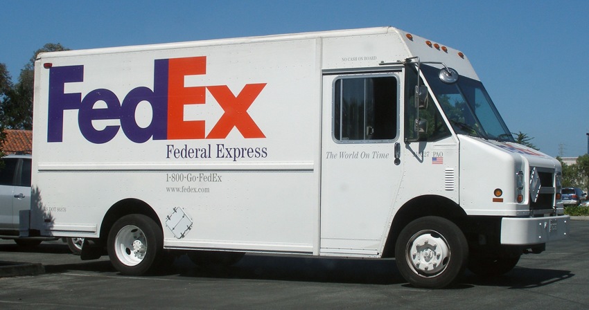 Photograph of a FedEx van, with iconic Fedex logo prominently emblazoned across the side.