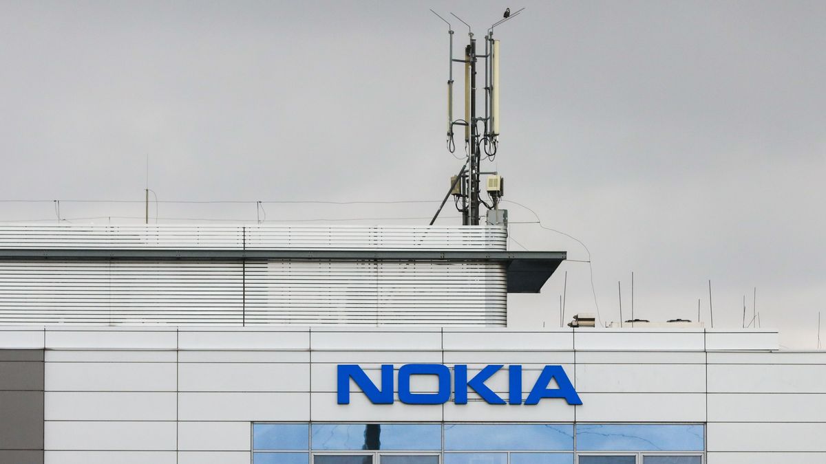 A cell mast sits atop a building marked with the word NOKIA