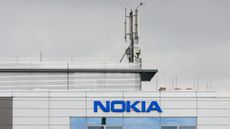 A cell mast sits atop a building marked with the word NOKIA