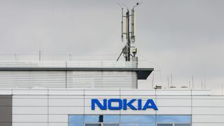 A cell mast sits atop a building marked with the word NOKIA