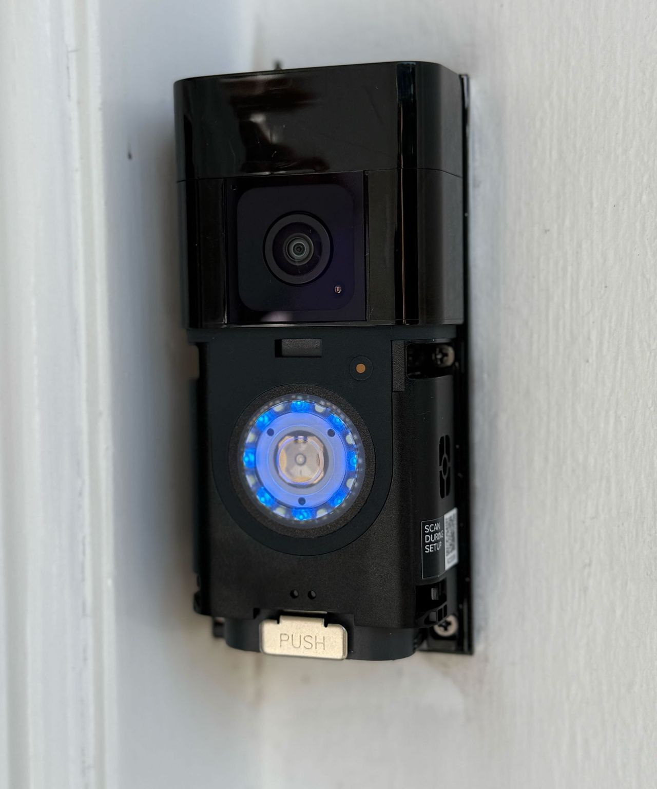 Ring Battery Doorbell Plus without the faceplate on a white wall