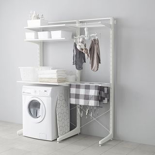 white utility room with washing machine and towels