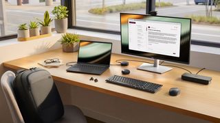 Dell Pro laptop on a desk connected to a docking hub, monitor, keyboard and mouse