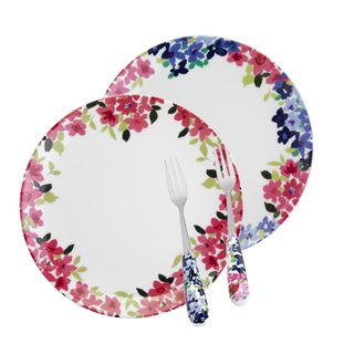 white plates and forks with floral design