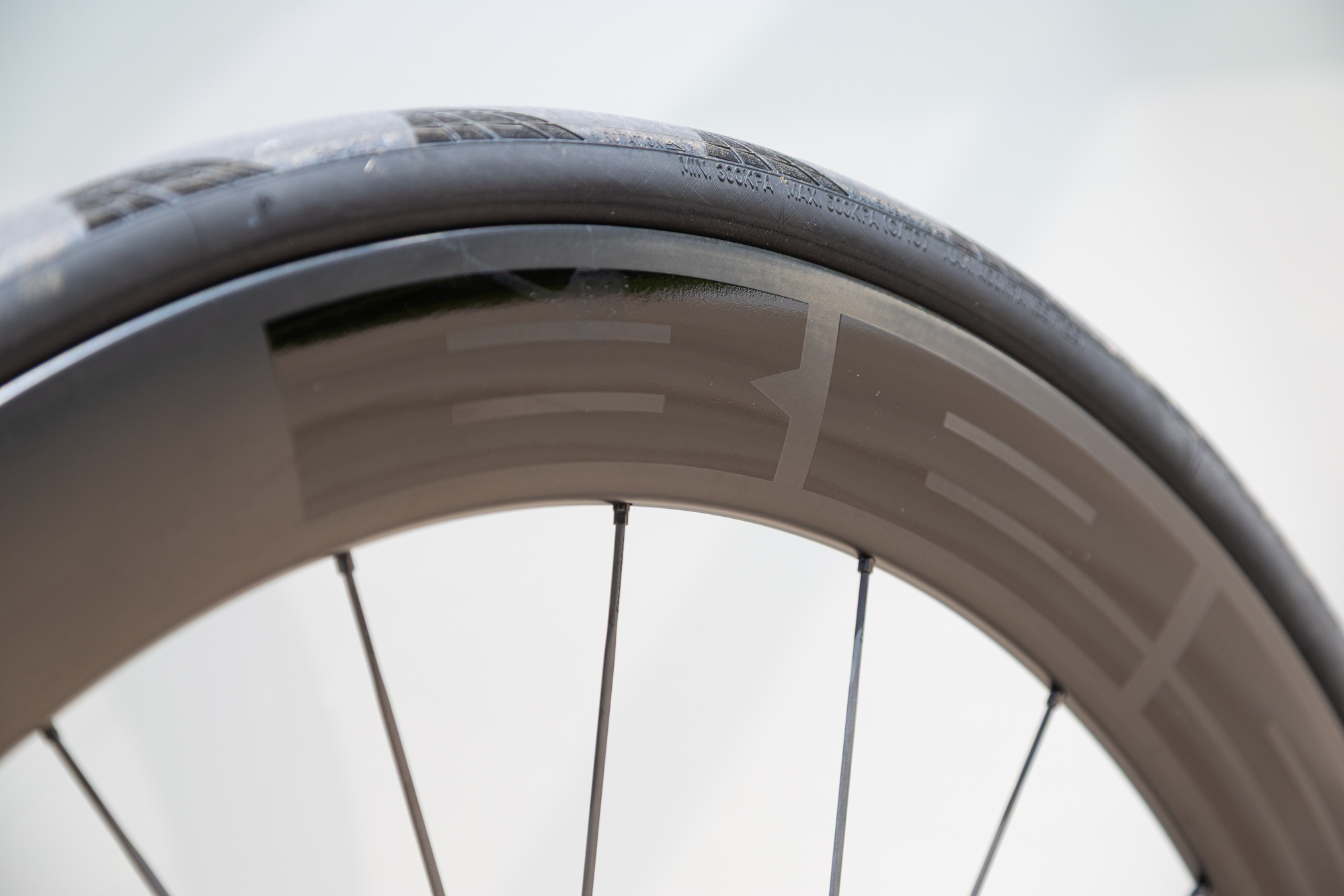 close up of a 60mm carbon rim and black tyre
