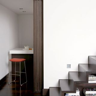 staircase with book shelves and wooden flooring