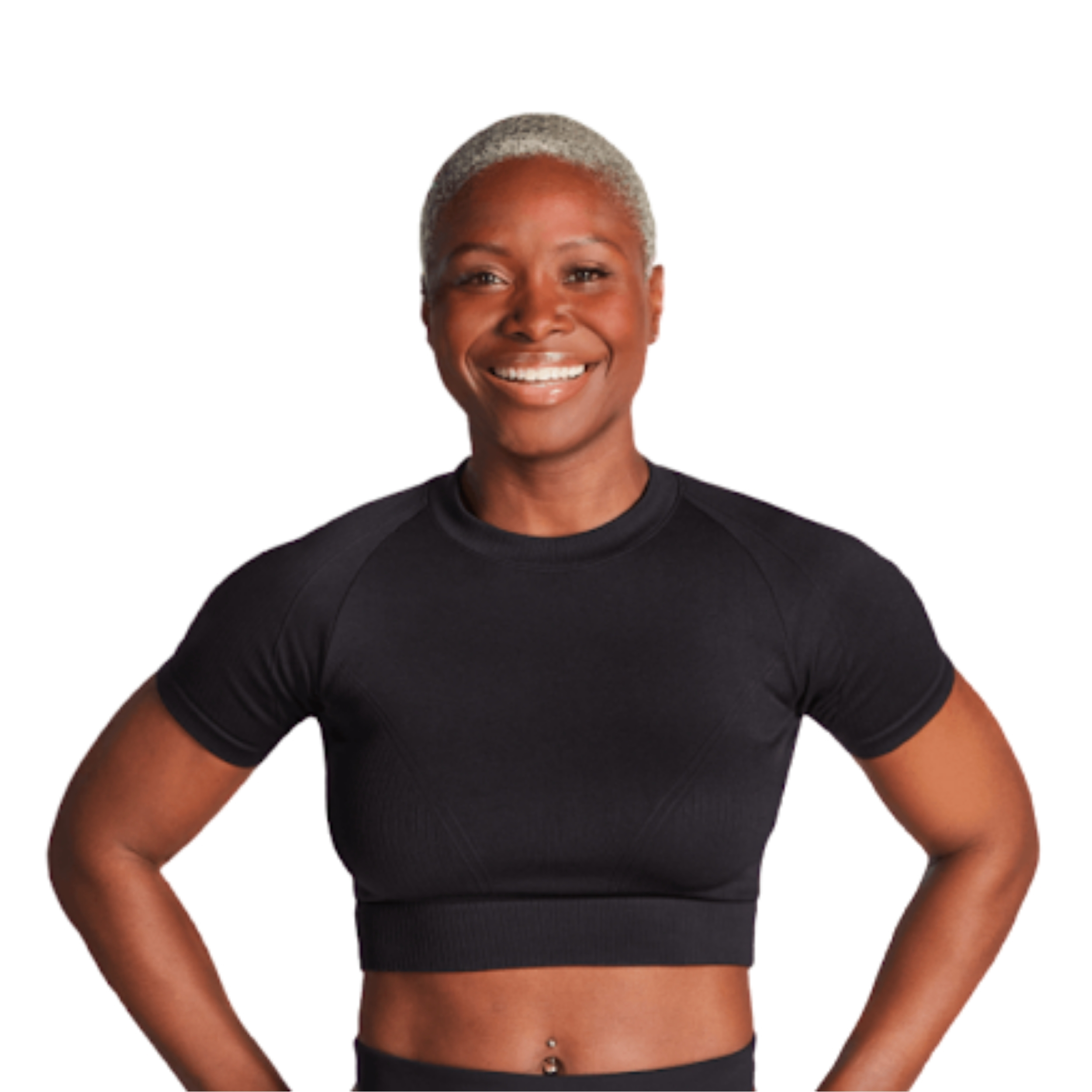 Woman smiles at camera. She is wearing a black crop top.