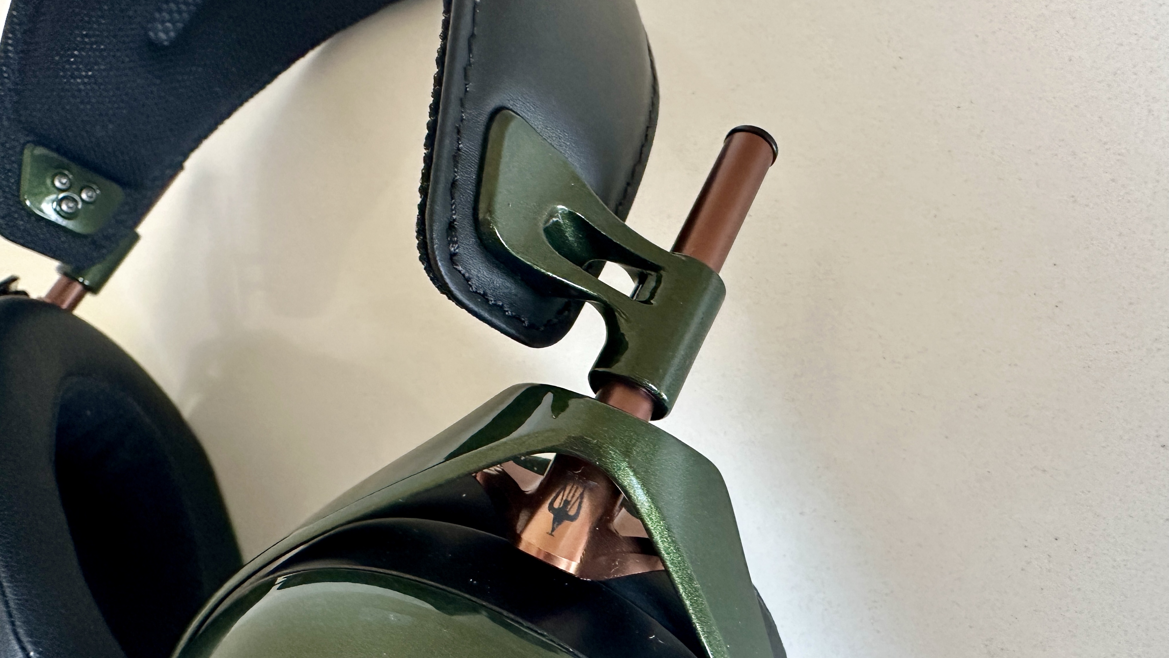 Meze Audio Strada headphones with wooden ear cups, in close-up and with their case and cables visible, on a white table